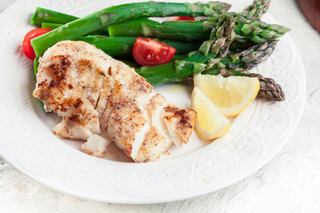 Fried cod fillet with green asparagus