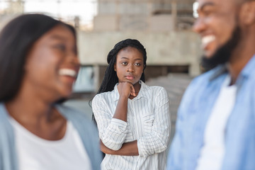 Upset black woman watching her ex boyfriend happy in new relations