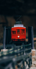 A red train on the side of a cliff