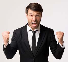 Emotional Businessman Screaming And Shaking Fists On White Background, Studio