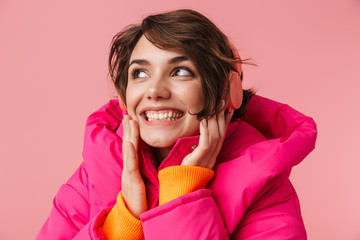 Portrait of young cheerful woman using headphones and smiling