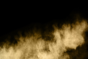 Golden powder explosion on black background.