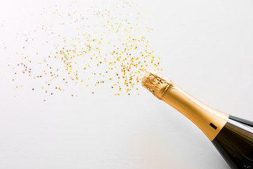 happy new year champagne and confetti bottle concept on white background