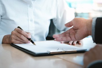 Legal counsel presents to the client a signed contract with gavel and legal law. justice and lawyer concept.