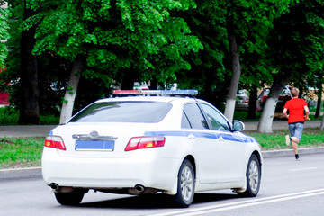 police car on city street, police work