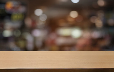 Empty dark wooden table in front of abstract blurred bokeh background of restaurant . can be used for display or montage your products.Mock up for space.