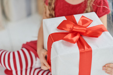 Hands of little boy with Christmas present. unrecognizable.