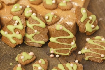 Christmas homemade gingerbread cookie sprinkled with green sugar on a wooden table