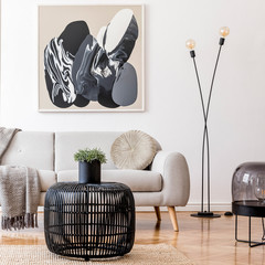 Stylish scandinavian living room interior with modern sofa, wooden commode, stylish lamps, plants,...