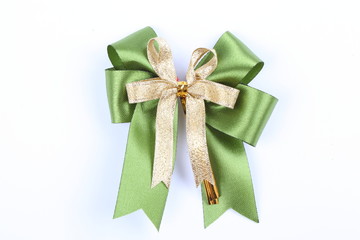 Decorative green & gold color ribbon bow on white background