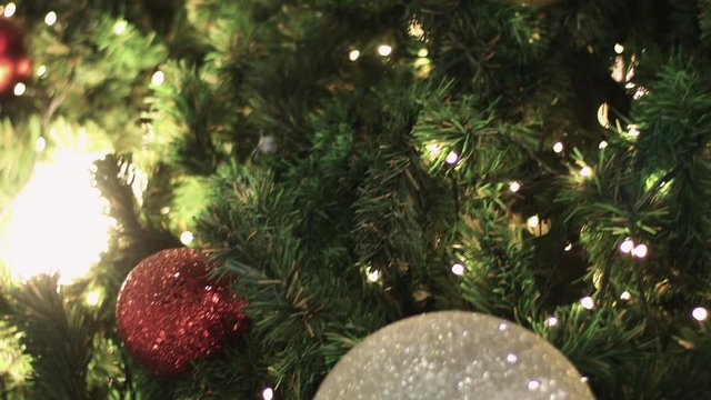 4k Close up, gold red decoration ball hanging on Christmas tree, X'mas and happy new year display, amber warm light, movement shot, holidays decoration events, joyful, fun time, happiness, bressing