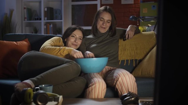 Girls watching movies together at home