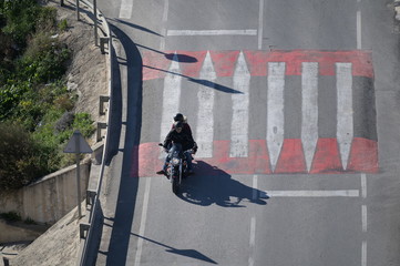 A man on a motorcycle drives over a threshold in Finestrat-Spain.
