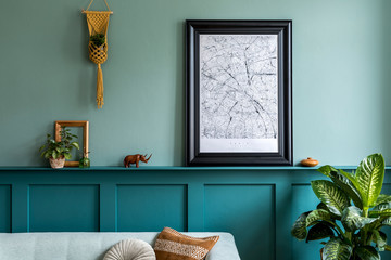 Stylish interior of living room with mock up poster map, mint sofa, plants, macrame and elegant...
