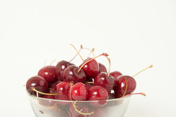 Fresh cherry glass bowl ready to serve. White background and perfect for adding text