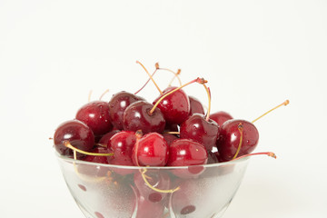 Fresh cherry glass bowl ready to serve. White background and perfect for adding text