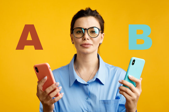conversion funnel, A B test in marketing and online advertising. Brunette woman holding colored letters A and B in hands with face expression.