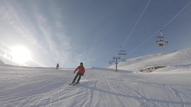 Man skiing on snowy slope at ski resort in the mountains