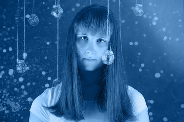 Portrait of young European female with crystal balls, looking at camera with serious expression. Horizontal.