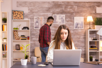 Caucasian woman working on laptop from home