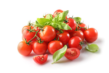Group of ripe red cherry tomatos and basil isolated on white background
