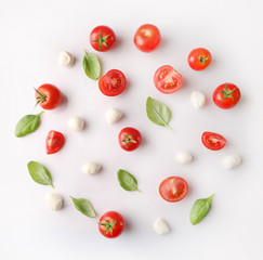 Rpe red cherry tomatos and mozzarella on white background.