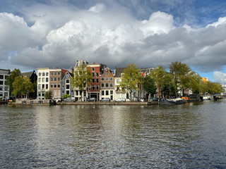Fototapeta na wymiar Amsterdam canal with typical dutch houses and houseboats, boats etc.