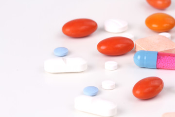 Drugs and medicines - different color pills on white background