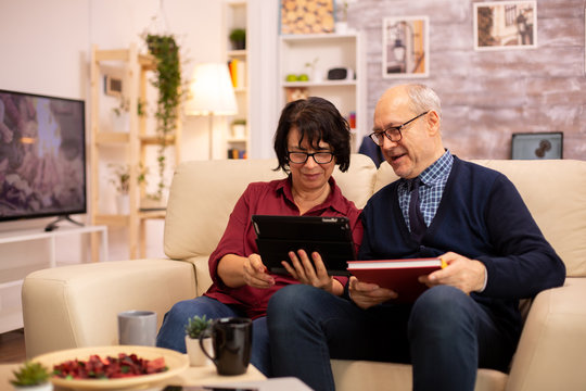 Beautiful old couple using a digital tablet to chat with their family