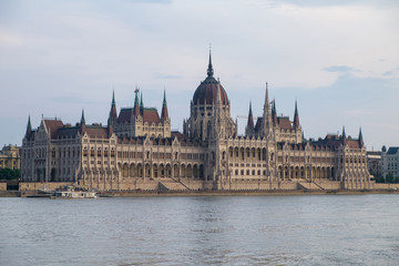 View of historical building of Hungarian Parliament on Danube river in Budapest, Hungary, Europe.