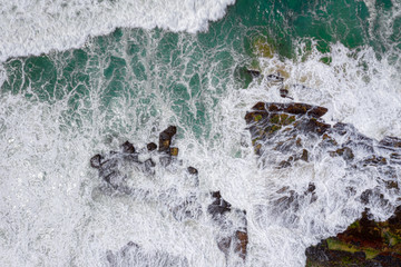 Overhead wave action over coastal rocks