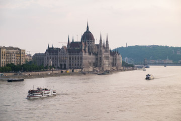 View of historical building of Hungarian Parliament and chain bridge on Danube river in Budapest, Hungary, Europe.