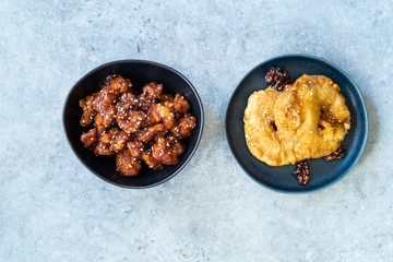 Asian Food Homemade Chinese General Tsos Chicken and Fried Pineapple Fritters Caramelized with Cinnamon and Sesame Seeds.