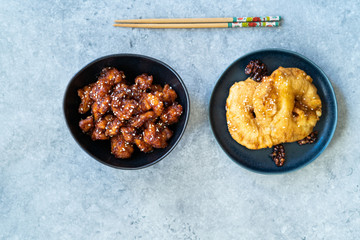 Asian Food Homemade Chinese General Tsos Chicken and Fried Pineapple Fritters Caramelized with Cinnamon and Sesame Seeds.