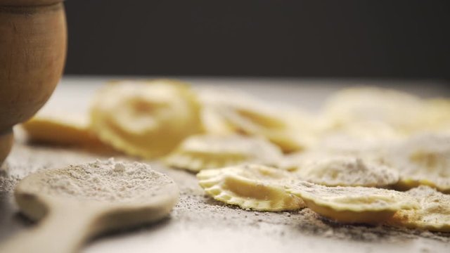 Cooking italian ravioli on wooden table. Top View with Copy Space.