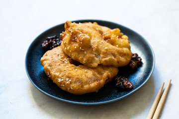 Fried Pineapple Fritters Caramelized with Cinnamon and Sesame Seeds.