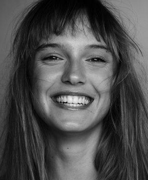 happy female model posing laughing black and white portrait. Beautiful laughing woman portrait. Pretty girl laughing portrait.