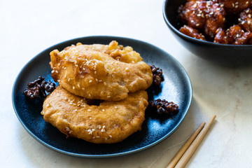 Fried Pineapple Fritters Caramelized with Cinnamon and Sesame Seeds.