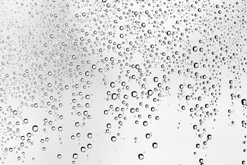 white isolated background water drops on the glass / wet window glass with splashes and drops of water and lime, texture autumn background