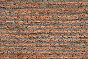 Red bricks wall texture and background. The fragment of bad and dirty bricklaying with cement smeared bricks. Сonstruction of a new multistory building. Construction site