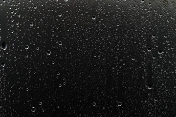 black wet background / raindrops for overlaying on window, concept of autumn weather, background of...