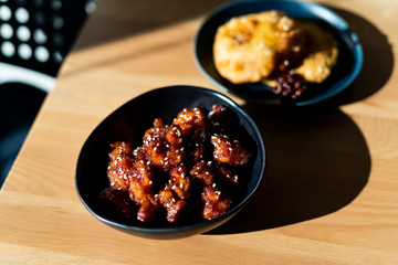 Asian Food Homemade Chinese General Tsos Chicken with Sesame Seeds served with Chopsticks.
