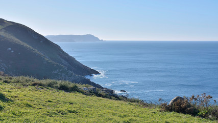 Fototapeta na wymiar Touriñan cliffs in Muxía, Costa da Morte, Galicia, Spain. These cliffs are the westernmost coast of the Spanish peninsular 