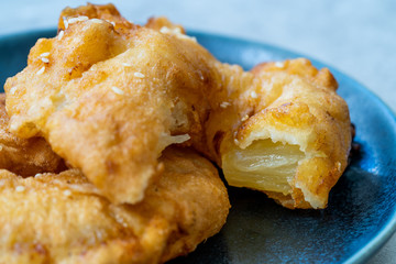 Fried Pineapple Fritters Caramelized with Cinnamon and Sesame Seeds.