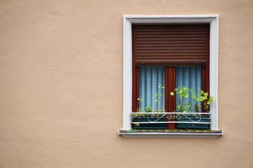 window on the pink facade of the house in Bilbao city, Spain