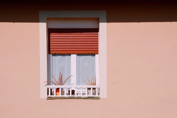 window on the pink facade of the house in Bilbao city, Spain