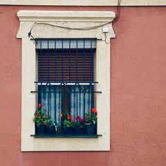 Fototapeta na wymiar window on the pink facade of the house in Bilbao city, Spain