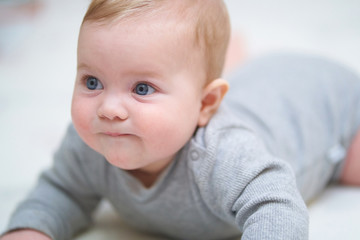 emotional portrait of a child. photo on a neutral background in gray clothes