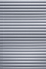 Obraz premium Close the window with gray blinds.Texture or background