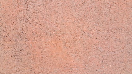 an old cracked wall outside, painted orange, the Paint of which was already very faded
